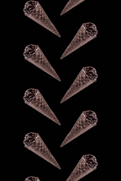 Elevated view of set of black ice cream isolated on black — Stock Photo