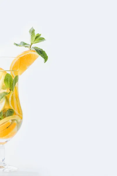 Close up view of summer fresh cocktail with mint and pieces of citrus fruits isolated on white — Stock Photo