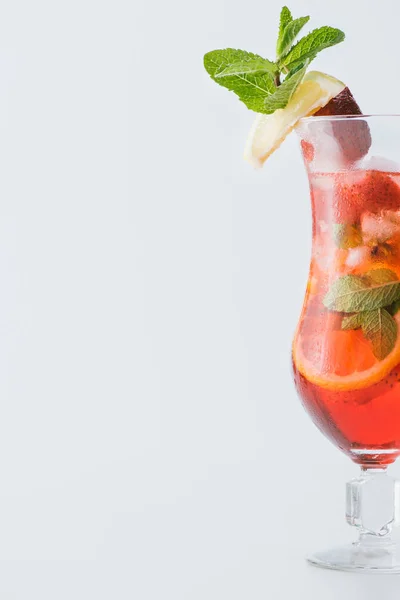 Close up view of summer strawberry cocktail with ice, mint, lemon and orange pieces isolated on white — Stock Photo