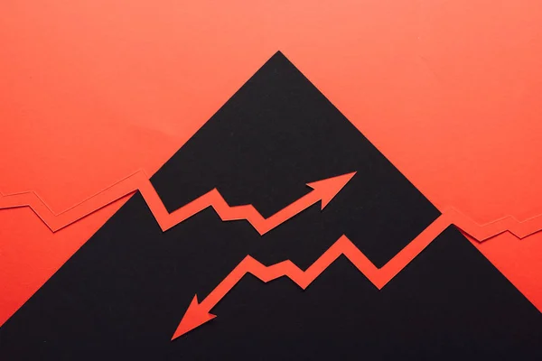 Top view of paper cur recession and increase arrows on black and red background — Stock Photo