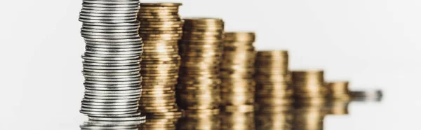 Selective focus of stacked silver and golden coins on surface with reflection isolated on white, panoramic shot — Stock Photo