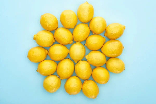 Top view of ripe yellow lemons on blue background — Stock Photo