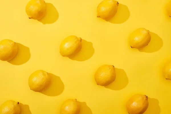 Top view of ripe lemons on yellow background — Stock Photo