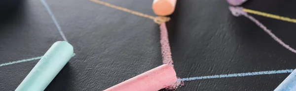 Panoramic shot of colorful chalk on black surface with connected drawn lines, connection concept — Stock Photo