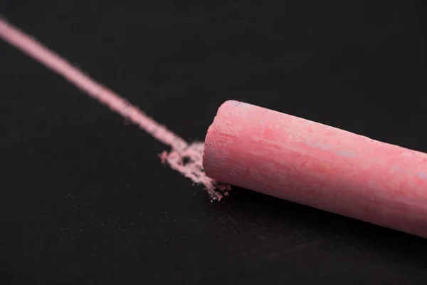 Close up view of pink chalk on black surface with drawn line, connection concept — Stock Photo