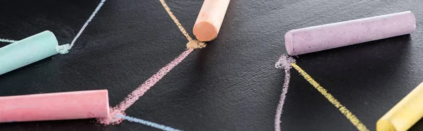 Panoramic shot of colorful chalk on black surface with connected drawn lines, connection concept — Stock Photo