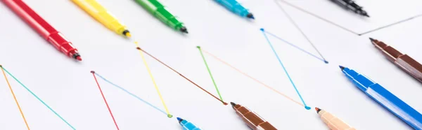 Panoramic shot of colorful felt-tip pens on white background with connected drawn lines, connection and communication concept — Stock Photo