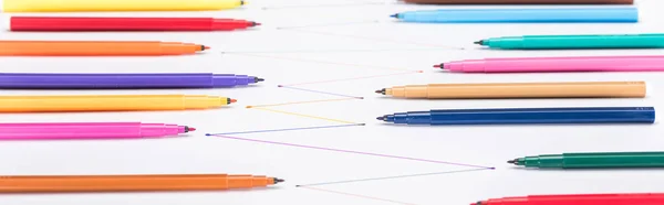 Selective focus of colorful felt-tip pens on white background with connected drawn lines, connection and communication concept — Stock Photo