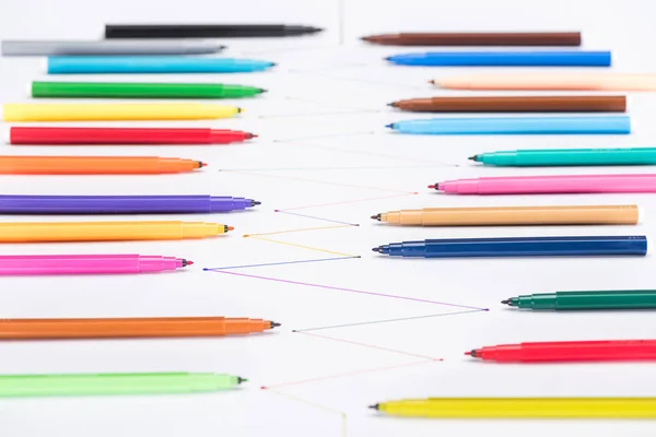 Selective focus of colorful felt-tip pens on white background with connected drawn lines, connection and communication concept — Stock Photo