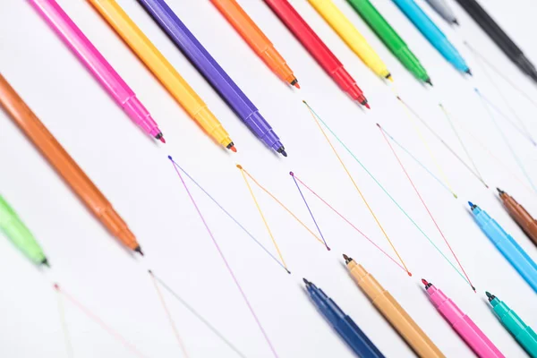 Colorful felt-tip pens on white background with connected drawn lines, connection and communication concept — Stock Photo