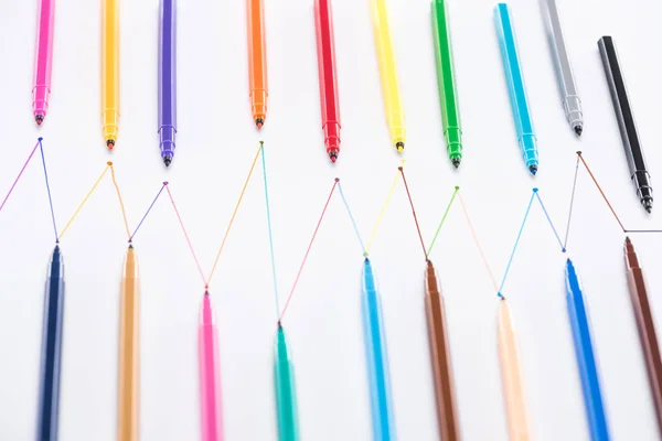 Vue de dessus des stylos feutre sur fond blanc avec lignes tracées connectées, concept de connexion et de communication — Photo de stock