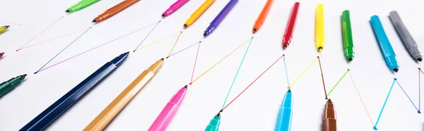 Panoramic shot of felt-tip pens on white background with connected drawn lines, connection and communication concept — Stock Photo