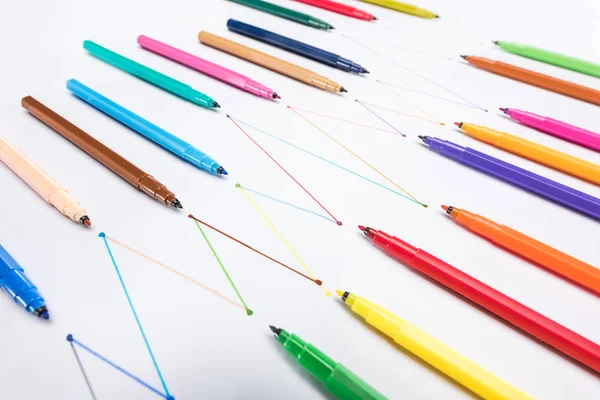 Multicolored felt-tip pens on white background with connected drawn lines, connection and communication concept — Stock Photo