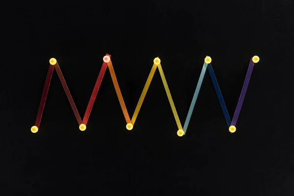 Top view of multicolored abstract connected lines with pins isolated on black, connection and communication concept — Stock Photo