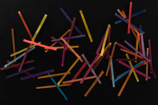 Top view of multicolored abstract lines isolated on black background, connection and communication concept — Stock Photo