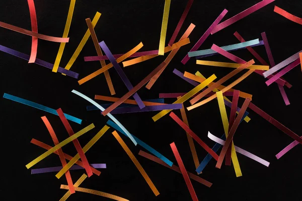 Top view of multicolored abstract lines scattered isolated on black background, connection and communication concept — Stock Photo