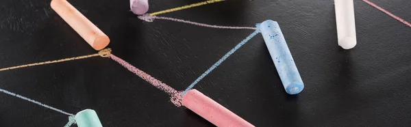 Panoramic shot of colorful chalk on black surface with connected drawn lines, connection and communication concept — Stock Photo