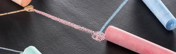 Panoramic shot of colorful chalk on black surface with connected drawn lines, connection and communication concept — Stock Photo
