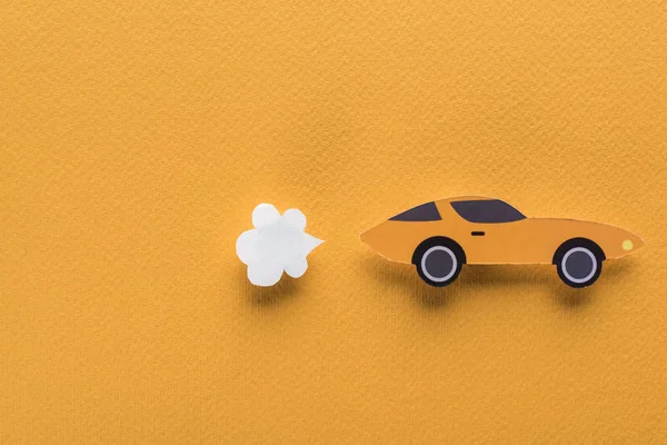 Top view of paper cut car on orange background with copy space — Stock Photo