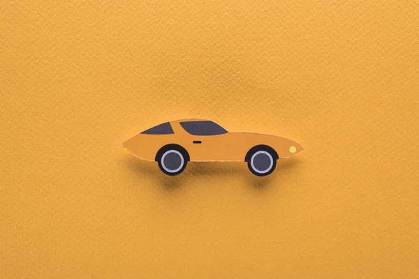 Vista superior del coche deportivo de corte de papel sobre fondo naranja, concepto de alquiler de coches - foto de stock