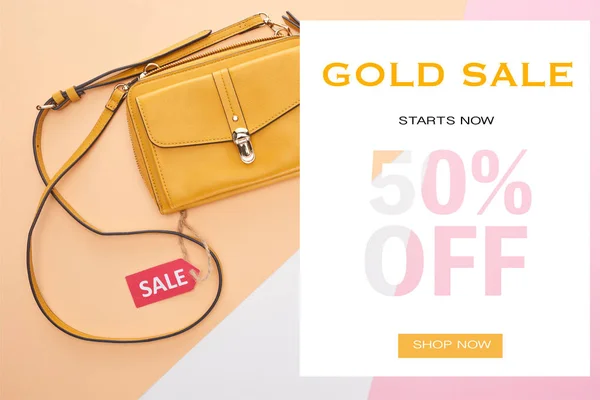 Top view of bag with sale label on beige, white and pink background with gold sale 50 percent off illustration — Stock Photo