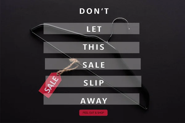 Top view of hanger with sale label on black background with dont let this sale slip away illustration — Stock Photo