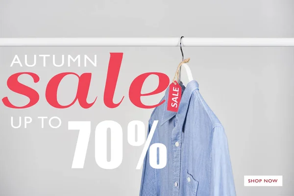 Blue shirt hanging with sale label isolated on white with autumn sale, up to 70 percent illustration — Stock Photo