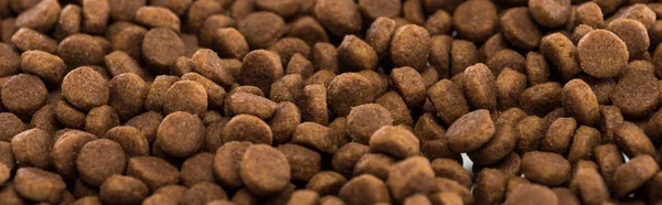 Brown dry pet food background with copy space, panoramic shot — Stock Photo