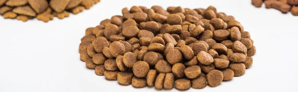 Selective focus of fresh dry pet food in pile isolated on white, panoramic shot — Stock Photo