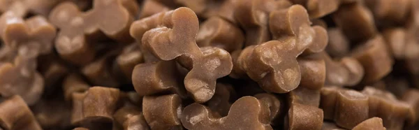 Close up view of fresh dry pet food in bones shape, panoramic shot — Stock Photo