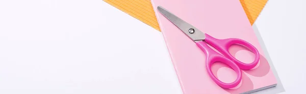 Panoramic shot of scissors, notebook and paper on white background — Stock Photo