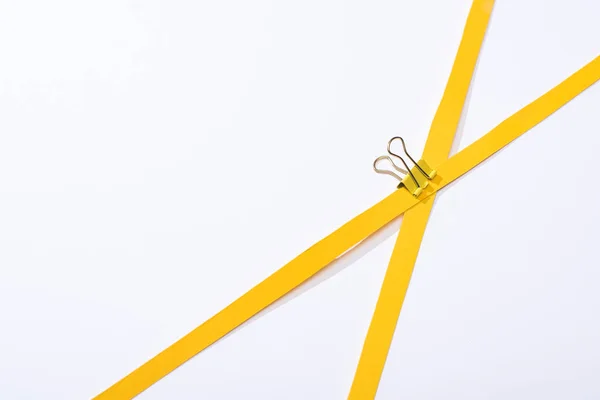 Top view of binder clip and paper strips on white background — Stock Photo