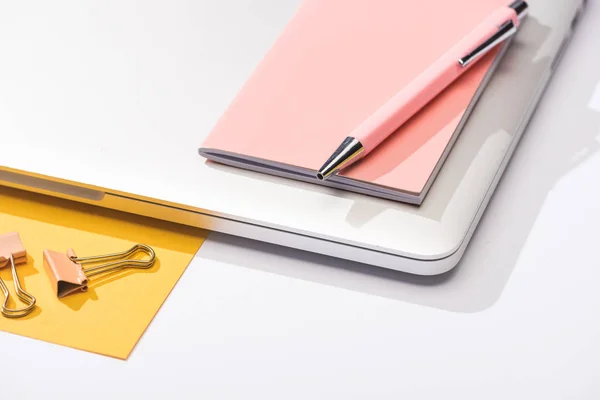 High angle view of laptop, paper, notebook, pen and paper clips — Stock Photo