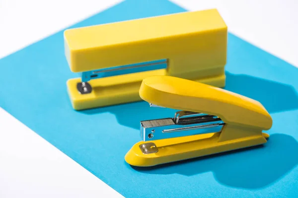 High angle view of staplers and paper isolated on white — Stock Photo