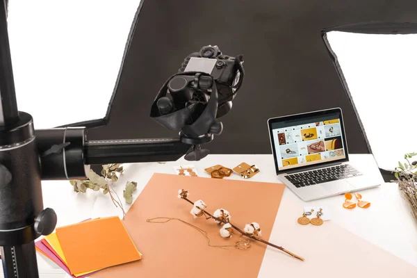 Composition with cotton flower and accessories for photo shooting with camera and laptop — Stock Photo