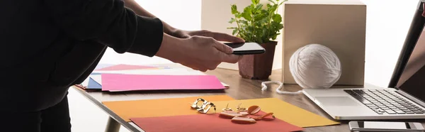 Cropped view of commercial photographer taking pictures of composition with accessories on smartphone — Stock Photo