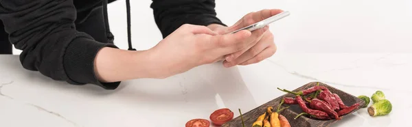 Cropped view of female photographer making food composition for commercial photography on smartphone — Stock Photo