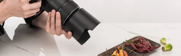 Cropped view of female photographer making food composition for commercial photography and taking photo on digital camera   on white — Stock Photo