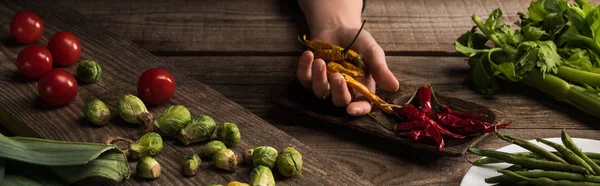 Cropped view of commercial photographer making food composition for photo shoot on wooden table — Stock Photo