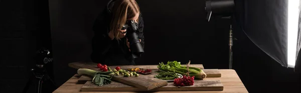 Professional photographer making food composition for commercial photography and taking photo on digital camera , panoramic shot — Stock Photo