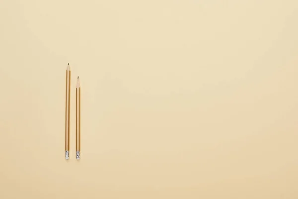 Flat lay with wooden pencils on beige background — Stock Photo