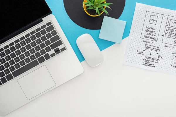 Top view of laptop, computer mouse, plant, website design template on abstract geometric background — Stock Photo