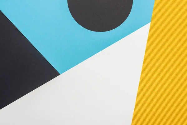 Top view of black, yellow, blue and white abstract geometric background — Stock Photo