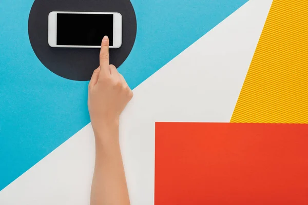 Cropped view of woman touching smartphone with blank screen on abstract geometric background — Stock Photo