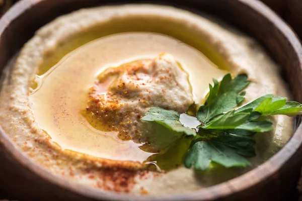 Close up view of fresh delicious hummus with parsley — Stock Photo