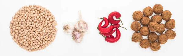 Top view of chickpea, garlic, chili pepper and falafel on white background, panoramic shot — Stock Photo