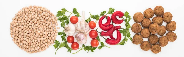 Top view of chickpea, garlic, cherry tomatoes, parsley, chili pepper and falafel on white background, panoramic shot — Stock Photo