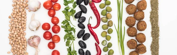 Top view of chickpea, garlic, cherry tomatoes, parsley, olives, chili pepper, green onion and falafel on white background, panoramic shot — Stock Photo