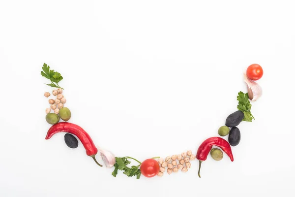 Top view of chickpea, garlic, cherry tomatoes, parsley, olives, chili pepper, green onion arranged in smile on white background — Stock Photo