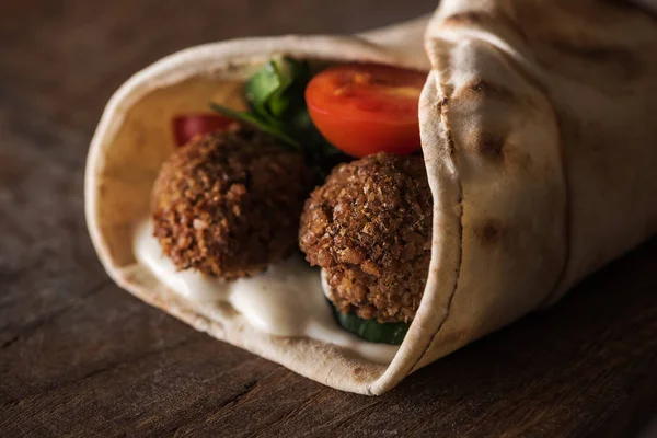 Nahaufnahme von Falafel mit Sauce und Gemüse in Pita — Stockfoto